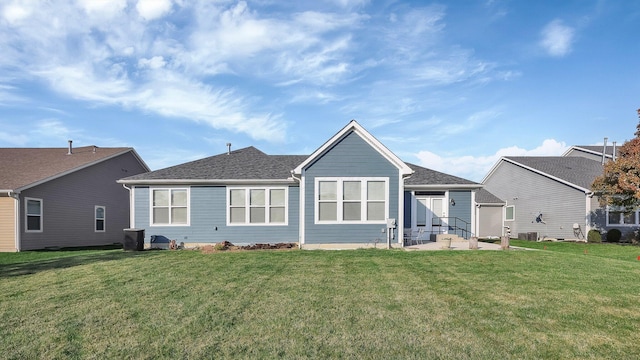 rear view of house featuring a lawn and a patio