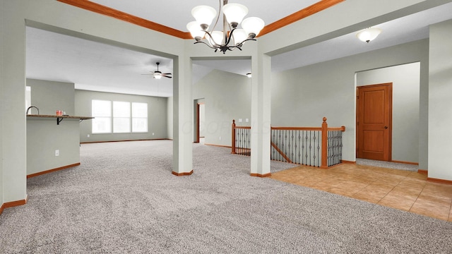 carpeted spare room with ceiling fan with notable chandelier and crown molding