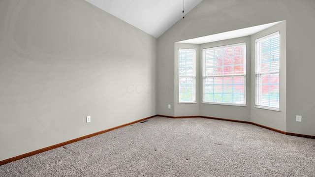 carpeted empty room featuring vaulted ceiling