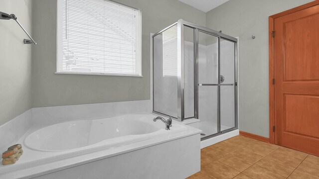 bathroom with tile patterned flooring and separate shower and tub