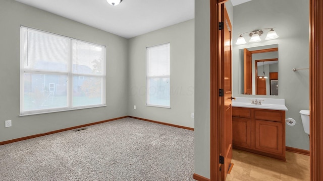 bathroom featuring vanity and toilet