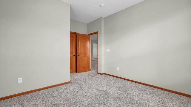 spare room featuring light colored carpet