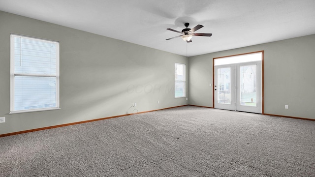 carpeted spare room with ceiling fan