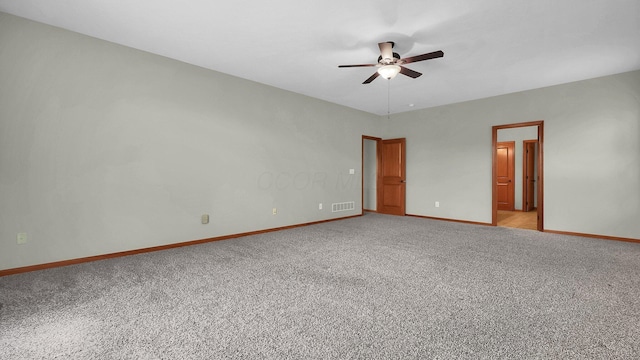 empty room with ceiling fan and light colored carpet