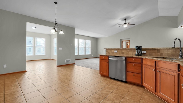 kitchen with stainless steel dishwasher, lofted ceiling, sink, and a wealth of natural light