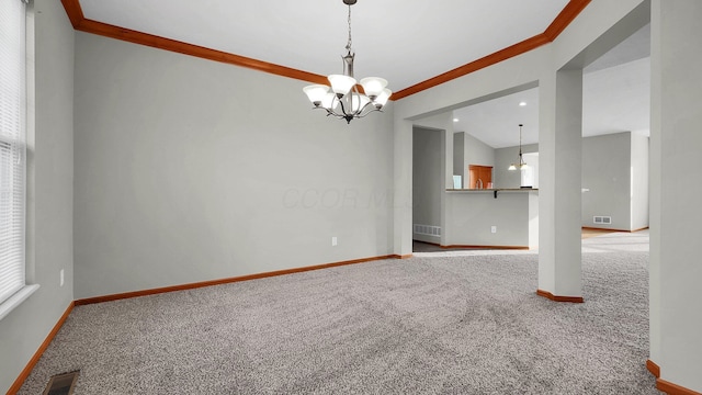 empty room with carpet flooring, a chandelier, and ornamental molding