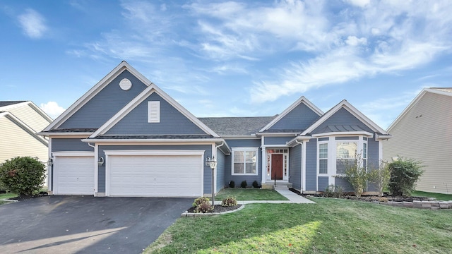 view of front of property with a front lawn and a garage