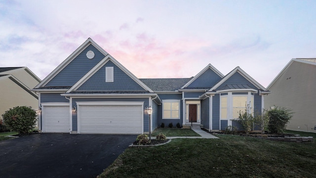 view of front of home featuring a yard and a garage