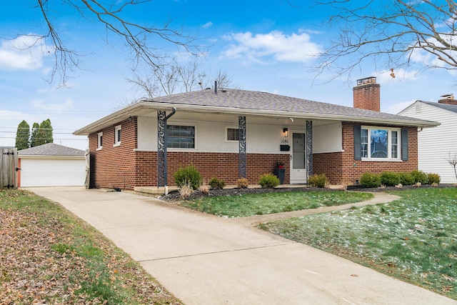 view of front of home with a garage, an outbuilding, and a front yard