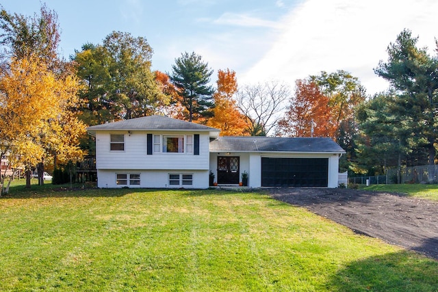 tri-level home featuring a front yard and a garage