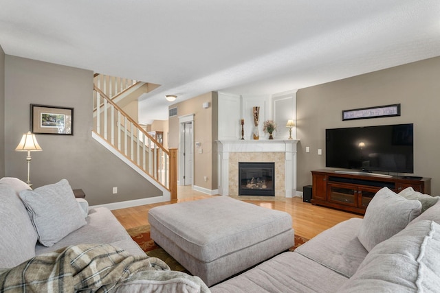 living room with a fireplace and light hardwood / wood-style flooring