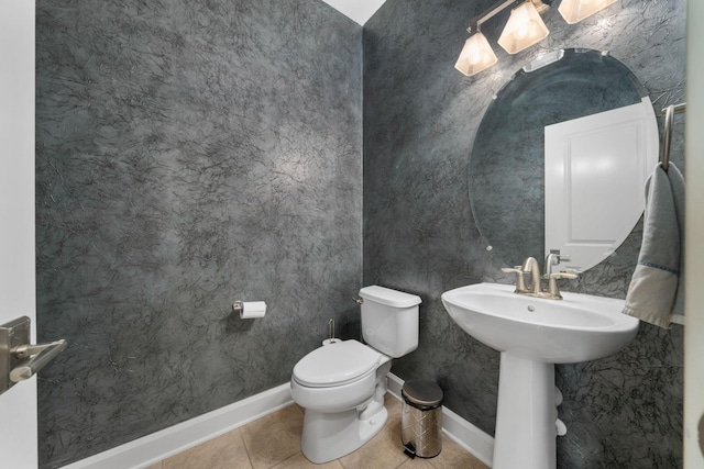 bathroom with tile patterned flooring, toilet, and sink