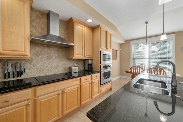 kitchen with backsplash, wall chimney exhaust hood, stainless steel appliances, sink, and light tile patterned flooring