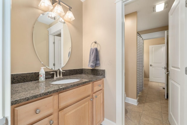 bathroom featuring tile patterned flooring and vanity