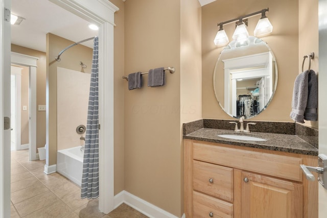 bathroom featuring tile patterned floors, vanity, and  shower combination