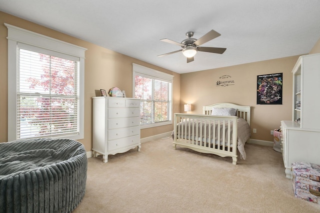 bedroom with ceiling fan and light carpet