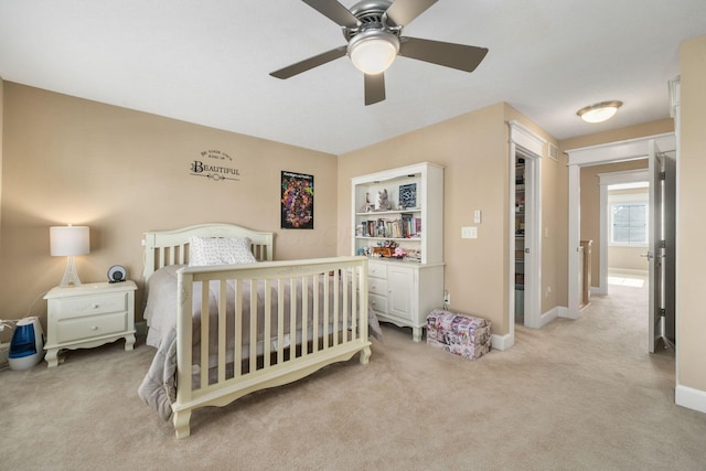 carpeted bedroom featuring ceiling fan and a closet