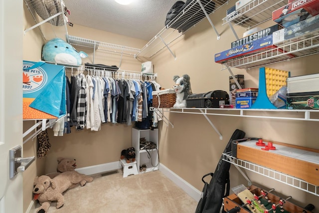 walk in closet featuring carpet floors