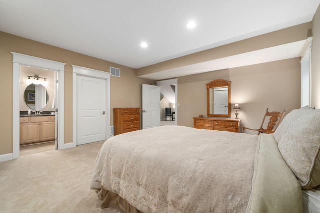 carpeted bedroom featuring ensuite bathroom