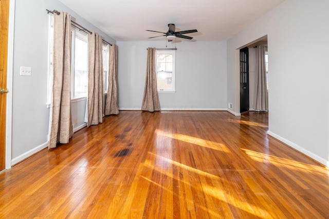 spare room with hardwood / wood-style flooring and ceiling fan