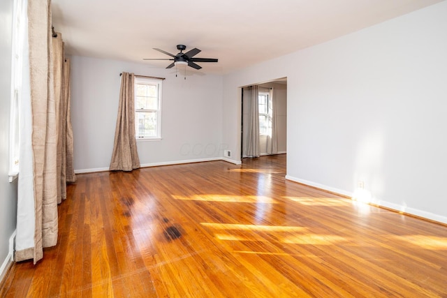 unfurnished room with ceiling fan and wood-type flooring