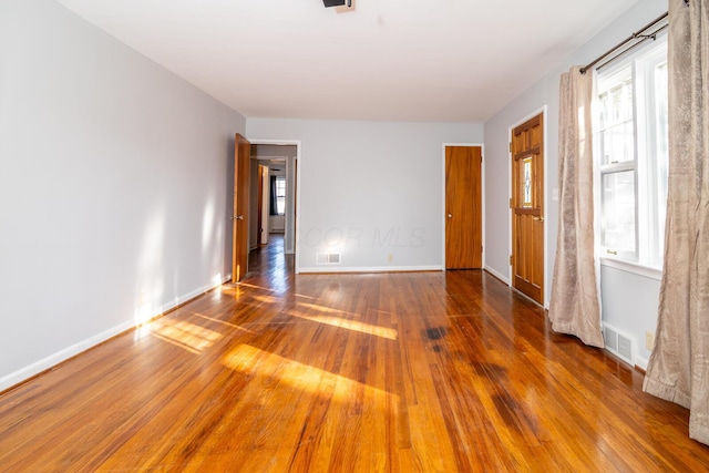 unfurnished room with hardwood / wood-style flooring