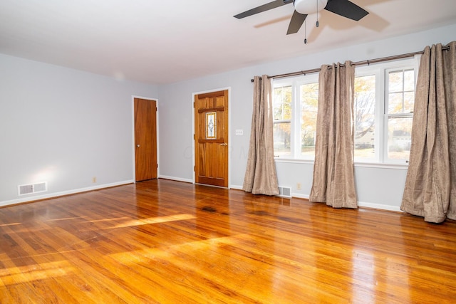 empty room with hardwood / wood-style flooring and ceiling fan