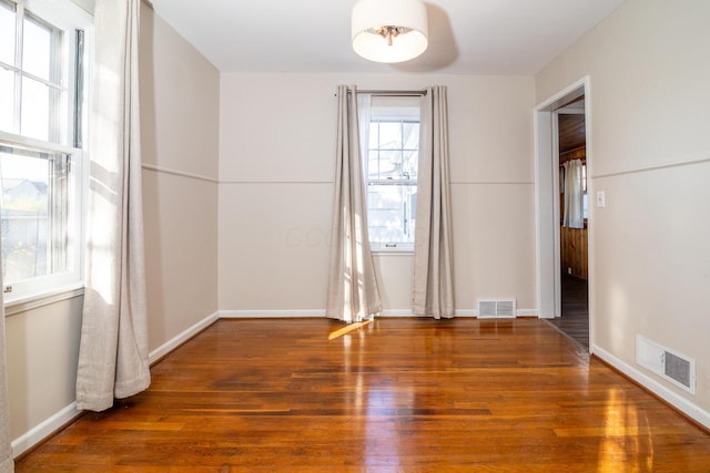 unfurnished room with dark wood-type flooring