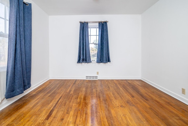 unfurnished room with wood-type flooring