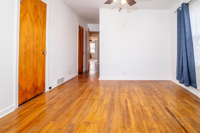 empty room featuring ceiling fan and light wood-type flooring