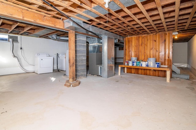 basement with washer and clothes dryer and heating unit