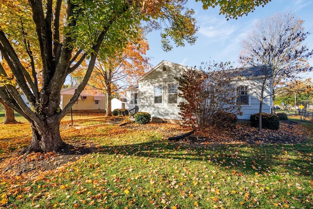 view of side of home with a lawn