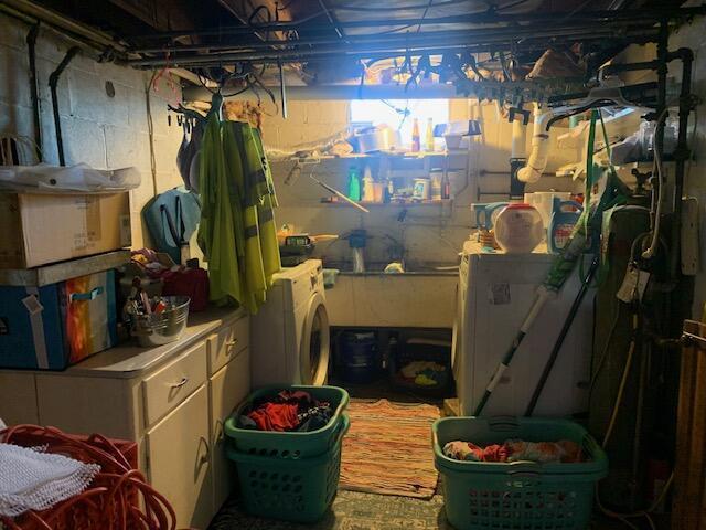 clothes washing area featuring washer / dryer