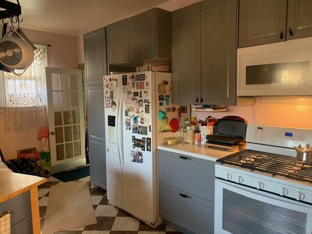 kitchen featuring gray cabinetry and white appliances