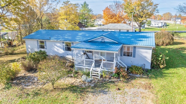 view of front of property with a porch and a front yard