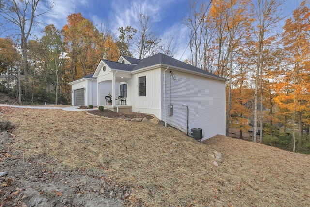 view of property exterior with a garage and central air condition unit