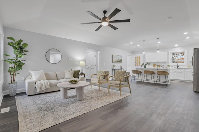 living room with ceiling fan, dark hardwood / wood-style flooring, and sink