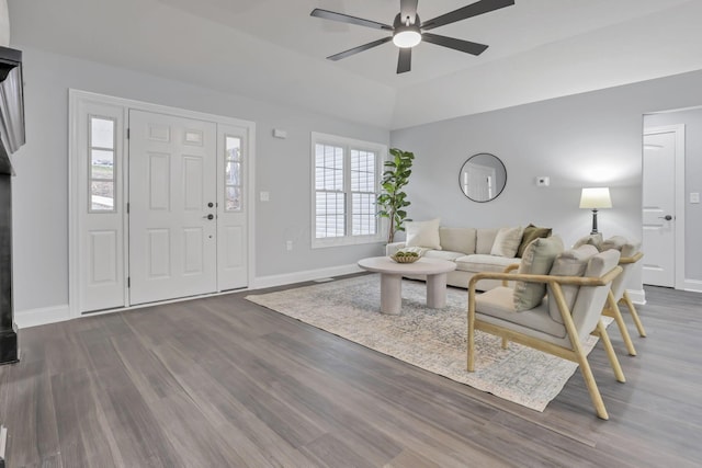 living room with plenty of natural light, dark hardwood / wood-style floors, ceiling fan, and vaulted ceiling