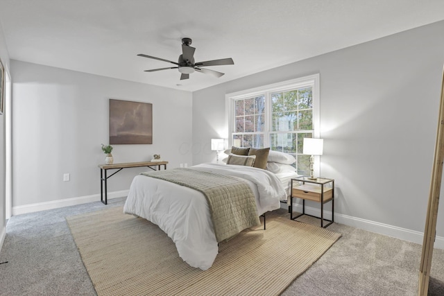 bedroom with ceiling fan and light carpet