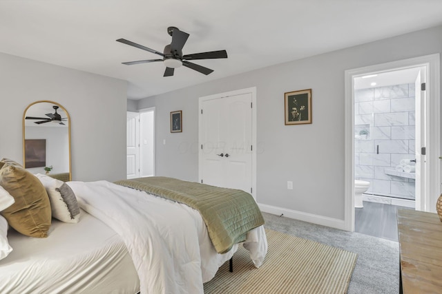 bedroom with ensuite bath, ceiling fan, a closet, and carpet floors