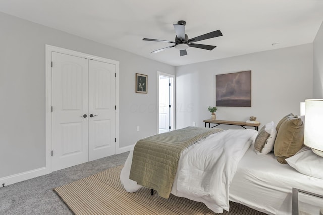 carpeted bedroom featuring a closet and ceiling fan