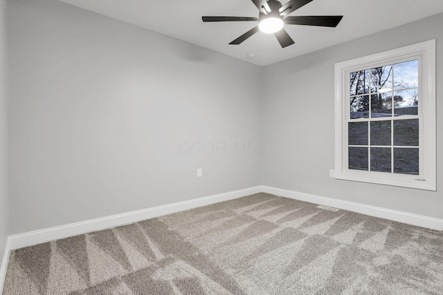 spare room featuring carpet and ceiling fan