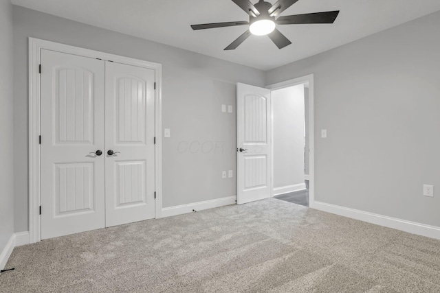 unfurnished bedroom featuring carpet flooring, ceiling fan, and a closet