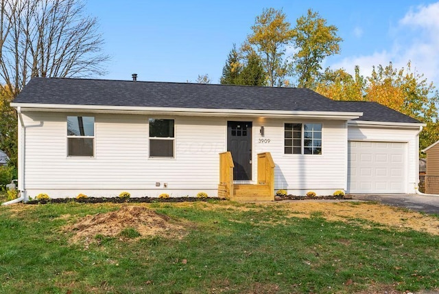 ranch-style house with a garage and a front lawn