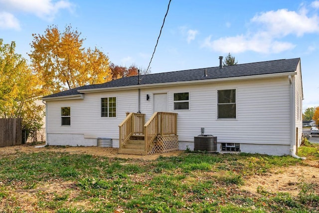 rear view of property featuring central AC