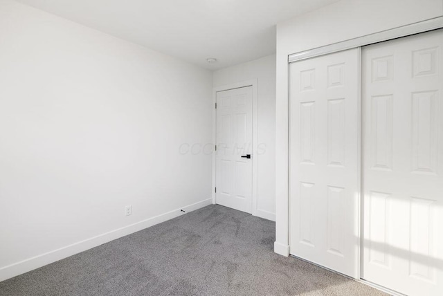 unfurnished bedroom featuring carpet floors and a closet