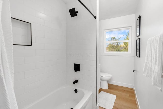 bathroom with hardwood / wood-style floors, toilet, and shower / bath combo with shower curtain