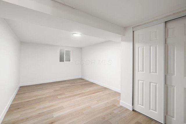 basement with light hardwood / wood-style flooring