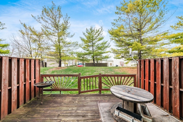 wooden deck featuring a yard