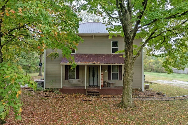 view of front of house featuring a front yard and central AC